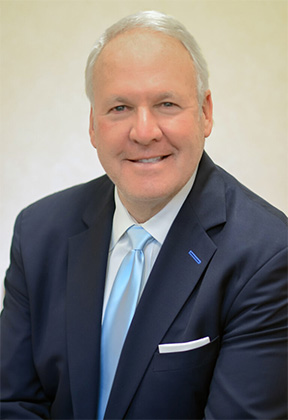 Man wearing a blue suit and light blue tie